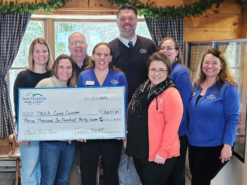 BHBT employees present a donation to YMCA Camp Coniston