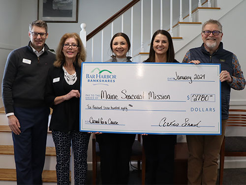BHBT employees present a donation to Maine Seacoast Mission