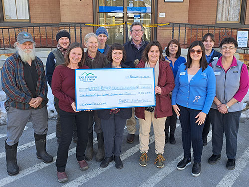 BHBT employees present a donation to White River Land Collaborative